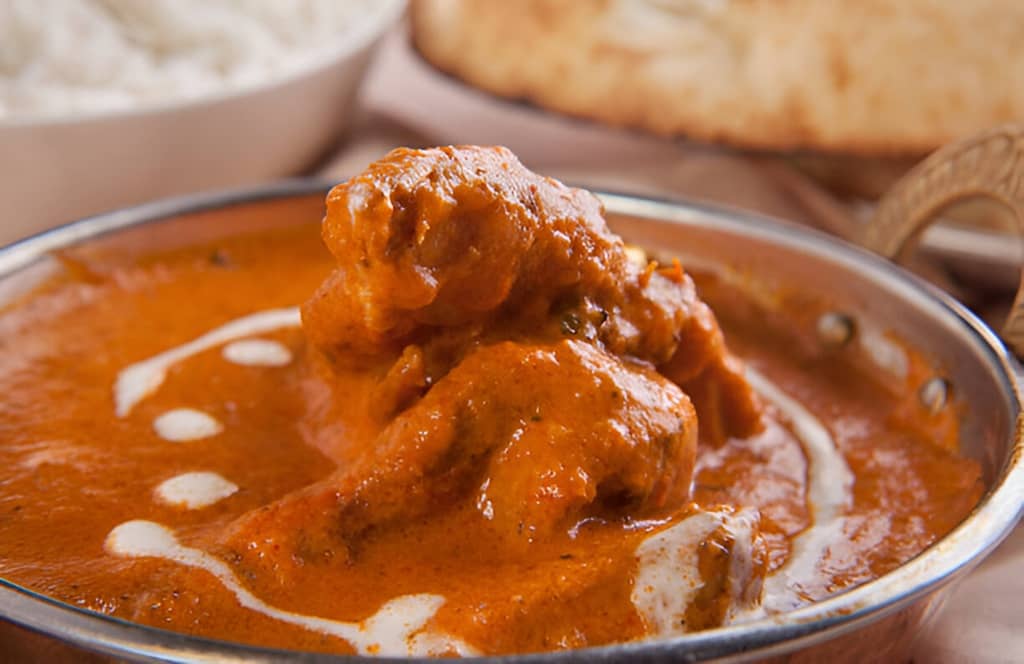 Discover 12 perfect side dishes to serve with butter chicken – from naan to lassi – and turn your meal into a flavorful Indian feast!