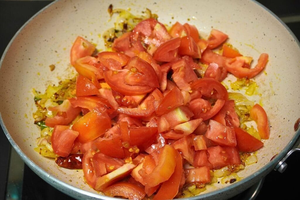 chopped tomato in frypan