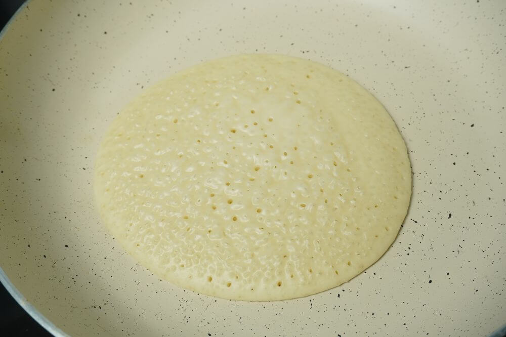 fluffy pancakes onside cooked and looking bubbles