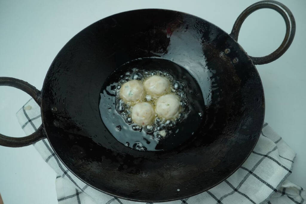 fried banana balls add balls to oil