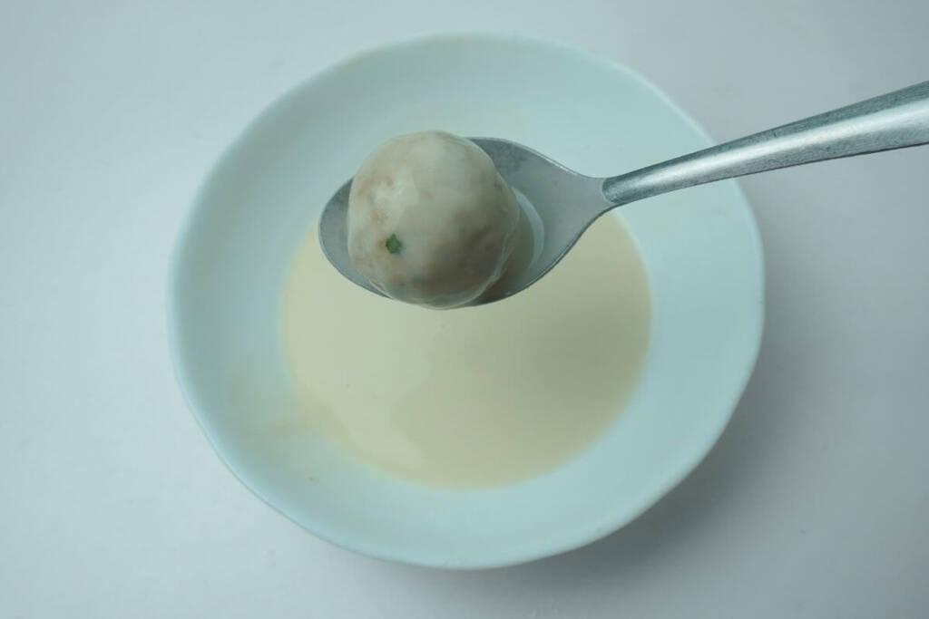 fried banana balls deep in slurry