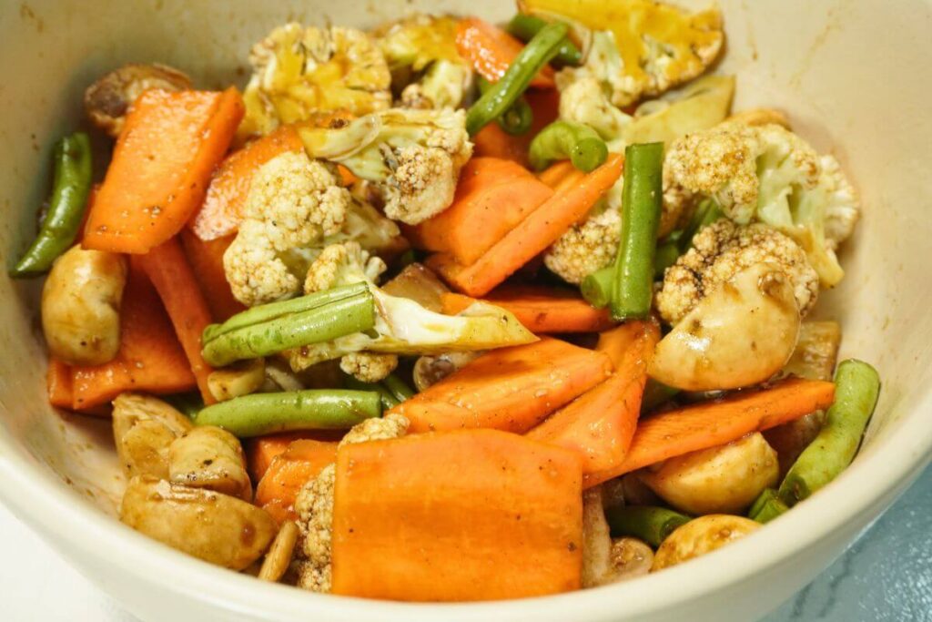 roasted vegetables in air fryer mixing