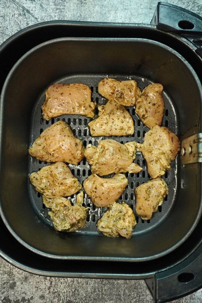 Chicken peaces in airfryer add airfryer basket