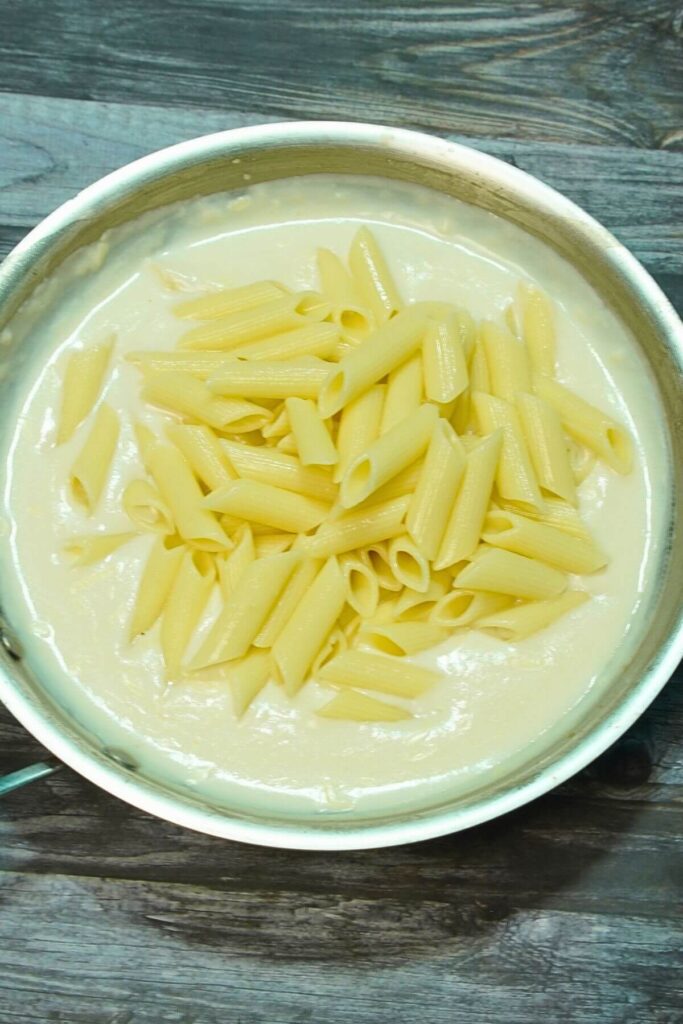 white cheesy pasta add pasta